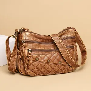 Vintage brown quilted crossbody bag with rivets and multiple zipper compartments