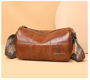 Brown oil wax leather barrel bag with vintage ethnic print strap and bronze hardware