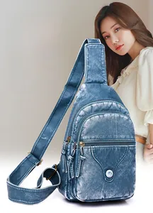 Detail of blue textured leather chest bag with wave flap and metal buckle detail