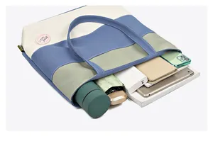 Spacious canvas bucket bag interior showing tablet, umbrella, and essentials storage