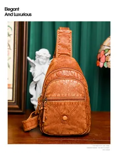 Close-up of caramel brown crossbody chest bag with soft leather texture and pockets