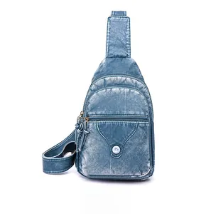 Detail view of the washed PU leather sling bag with multi-zipper layers and fringe pullers