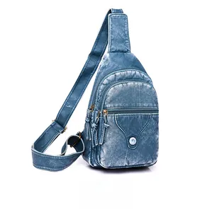 Detail of vintage blue crossbody chest bag showing washed PU leather texture and zip pockets