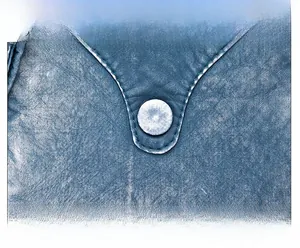 Detail of blue leather bag showing silver round rivet and neat white stitching craft