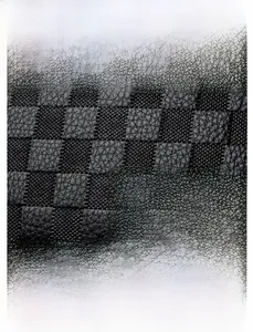 Detail of black textured leather bag with gold kangaroo logo and water-resistant finish