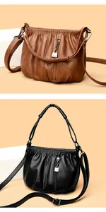 Detailed close-up of soft leather bucket bags featuring pleated texture and metal zippers
