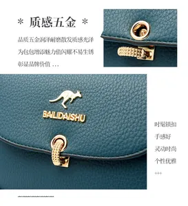 Detail view of deep teal pebble leather bag with gold buckle and kangaroo logo