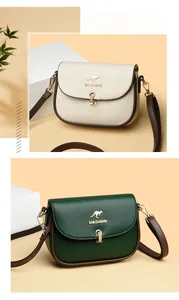 Detail of lychee pattern leather bags in beige and green with golden kangaroo logo