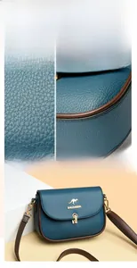 Close-up of dark blue lychee grain leather texture with golden kangaroo logo and metal lock