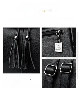 Detail of black pebbled leather backpack with tassel drawstring and silver kangaroo zipper