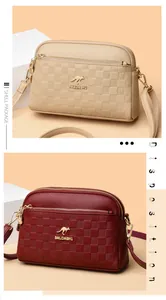 Three-layer zip shell crossbody bags in beige and red with gold kangaroo hardware details
