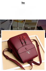 Detail of burgundy leather backpack with litchi texture, tassel, and kangaroo emblem