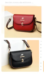 Detail of red and black lychee grain leather crossbody bags with golden kangaroo logo
