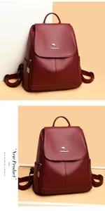Detailed close-up of wine red textured leather backpack with gold kangaroo logo and handle