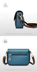 Detail view of blue litchi leather crossbody bag with brown trim and gold hardware