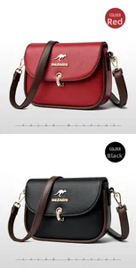 Detailed comparison of red and black leather crossbody bags with gold kangaroo hardware