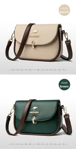 Close-up of leather shoulder bags in apricot and dark green with metal clasps