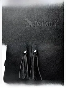 Close-up of litchi texture leather backpack with brand logo and double tassel details
