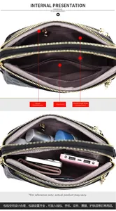 Internal structure of the black leather crossbody bag showing dual pockets and zippers