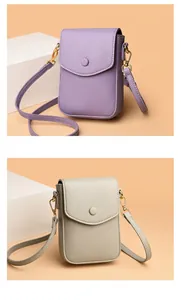 Detail view of purple and beige leather phone crossbody bags with gold hardware and flap