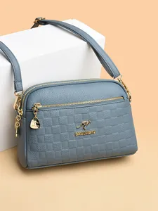 Elegant grey-blue leather crossbody bag with square embossed pattern and gold hardware