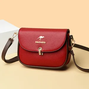 Women's red litchi grain leather crossbody bag with golden kangaroo logo and brown strap