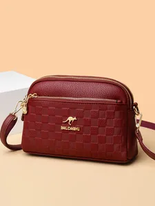 Burgundy leather crossbody bag with three zipper compartments and gold kangaroo logo