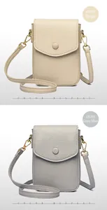 Detail of minimalist leather phone bags in beige and grey-blue with pebble texture