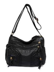 Black washed faux leather crossbody bag with triple zippers and woven detail