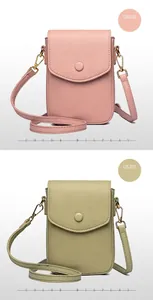 Detail of pink and green leather phone bags with litchi texture and magnetic flap closure