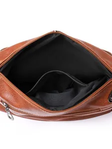 Top view of large brown soft leather shoulder bag with interior zipper pocket compartments