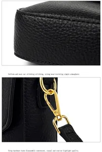 Macro detail of black lychee leather bag corners and golden metal hook hardware