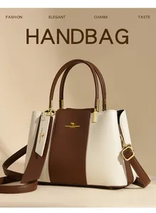 Detail of two-tone leather tote bag with gold hardware and MAIKEKANGAROO logo