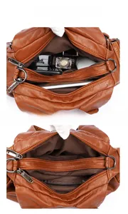 Détail de la structure intérieure multi-poches du sac en cuir brun pour mobile et argent