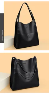 Close-up of black pebble grain leather tote bag with embossed kangaroo logo detail