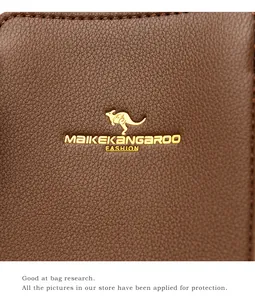 Macro view of dark brown lychee grain leather with high-end golden kangaroo metal logo
