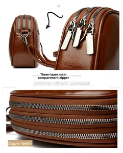 Detail of three independent zipper compartments and durable metal teeth on brown handbag