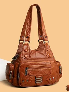 Grand sac à main vintage en cuir marron avec plusieurs poches et détails métalliques