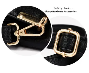 Close-up of black lychee leather strap with shiny gold swivel hook and adjustable buckle