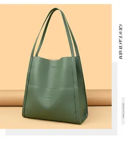 Detail of dark green tote bag featuring lychee grain texture and kangaroo brand logo