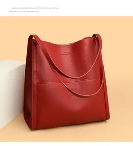 Macro shot of red pebble grain leather tote bag showing high-quality texture and twin straps