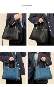 Detail of floral embossed leather handbag with golden hardware and adjustable strap