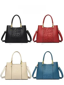 Four-color display of leather handbags featuring floral embossing and gold hardware