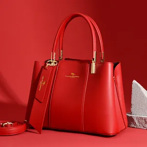 Red leather tote bag for women with golden hardware and adjustable strap by Maikekangaroo