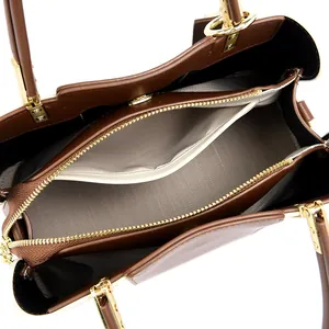 Top view of dark brown leather handbag showing spacious interior and golden hardware
