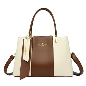 Chic two-tone leather handbag in cream and brown with top handles and shoulder strap
