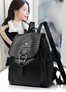 Detail of black faux leather backpack with metallic kangaroo logo and woven texture finish