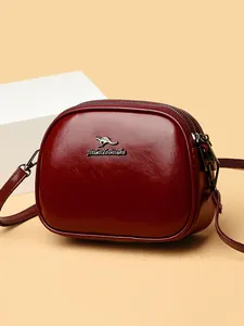 Fashionable burgundy oil wax leather crossbody bag with multiple zipper compartments