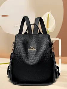Detail of black lychee texture backpack with golden kangaroo logo and floral decor