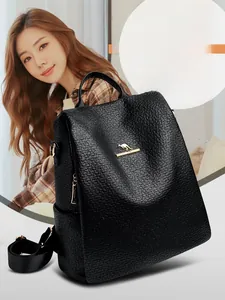 Detailed close-up of black leather backpack with lychee grain and golden kangaroo logo